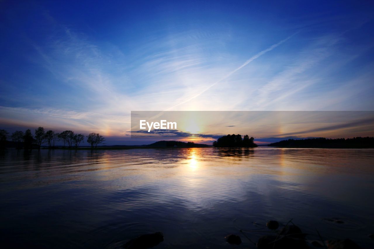 Scenic view of lake against sky during sunset