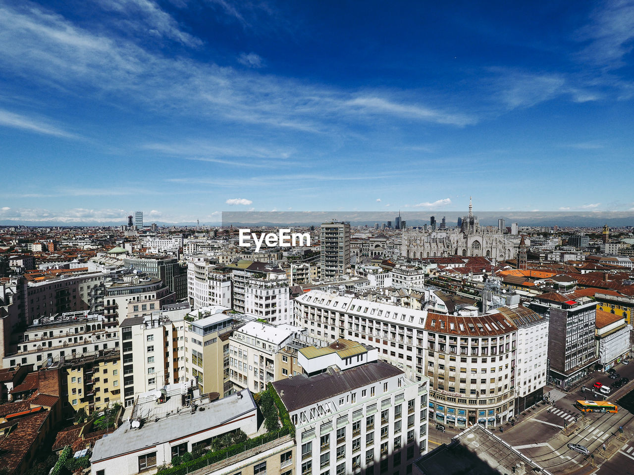 Aerial view of cityscape against sky during sunny day