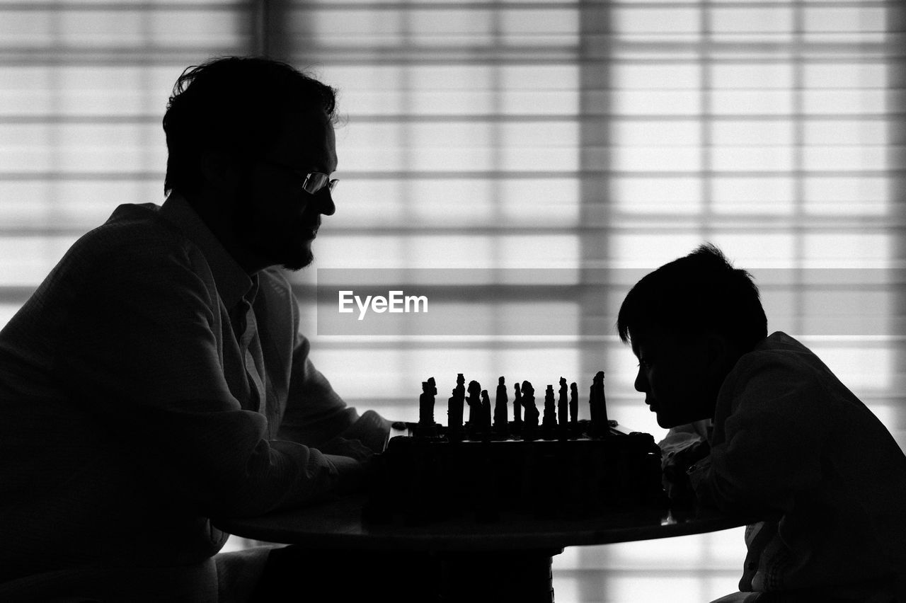 Silhouette of man playing chess