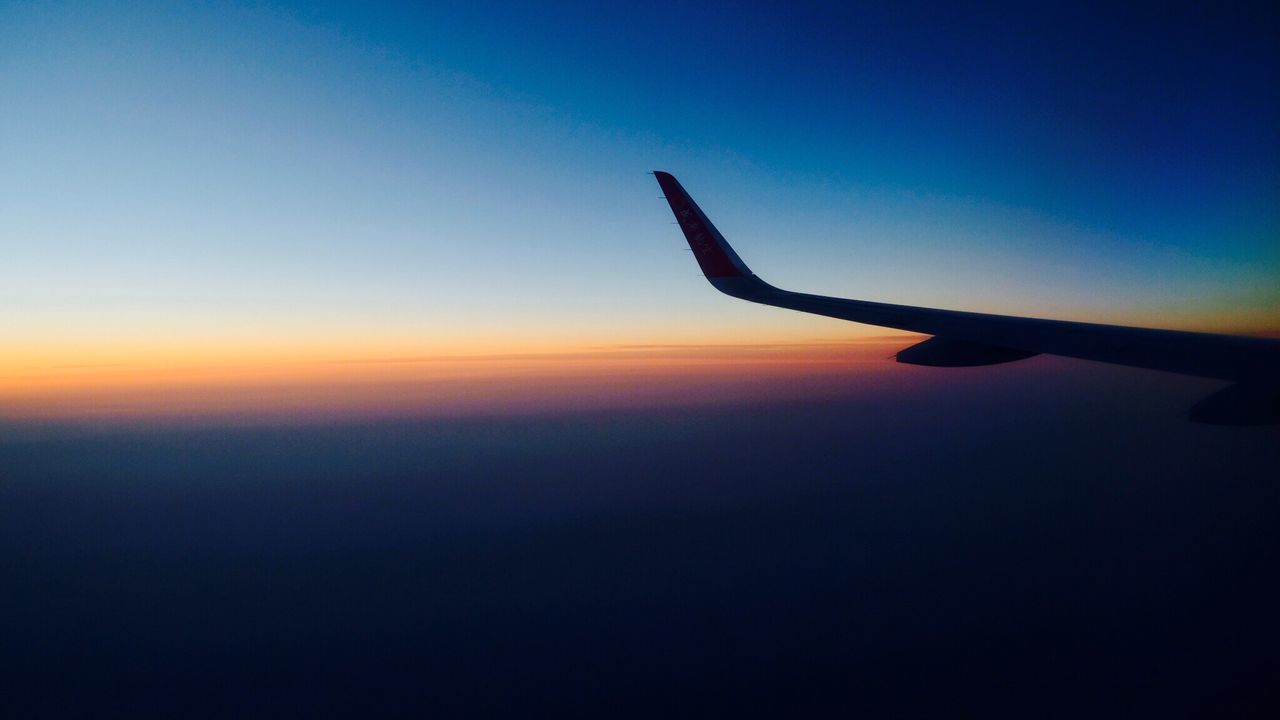 SILHOUETTE AIRPLANE WING AGAINST CLEAR SKY