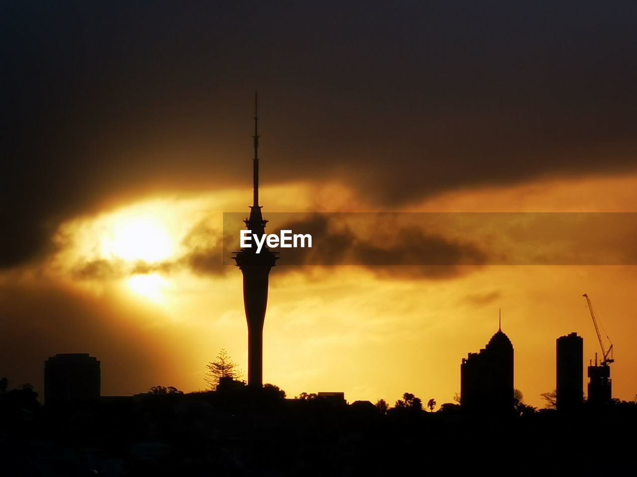 sky, architecture, built structure, silhouette, sunset, building exterior, tower, skyline, city, horizon, dawn, communications tower, building, evening, nature, afterglow, travel destinations, cloud, no people, skyscraper, cityscape, landscape, urban skyline, outdoors, orange color, office building exterior, travel, dramatic sky, spire, sun, city life