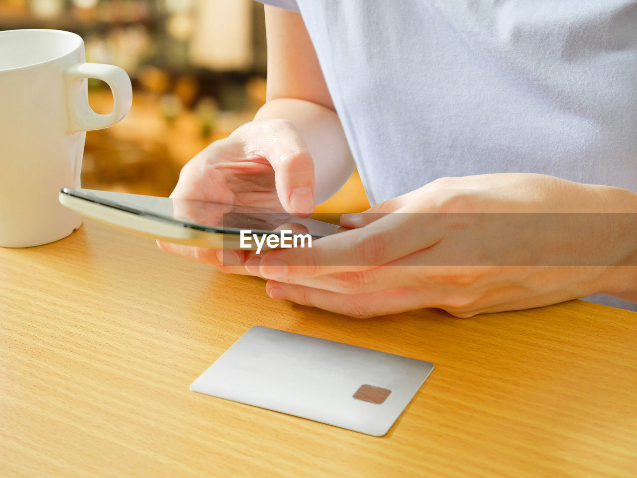 midsection of woman using digital tablet