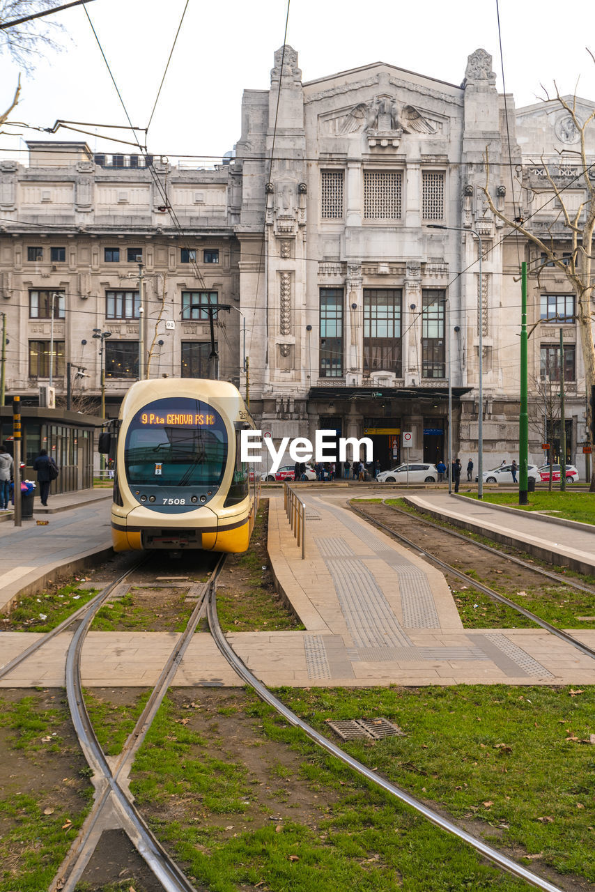 A tram departing from central station with the the main station in the background