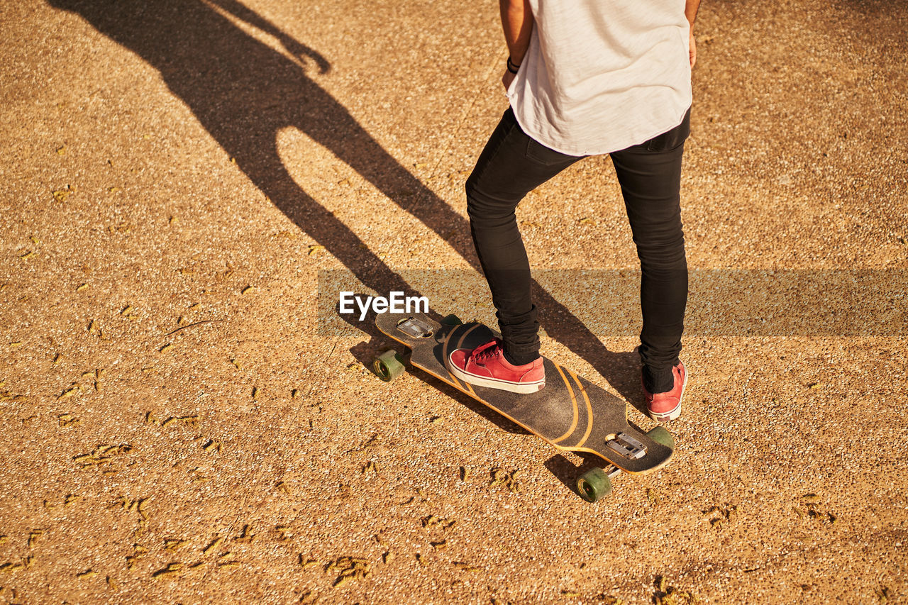 Low section of man skateboarding on skateboard