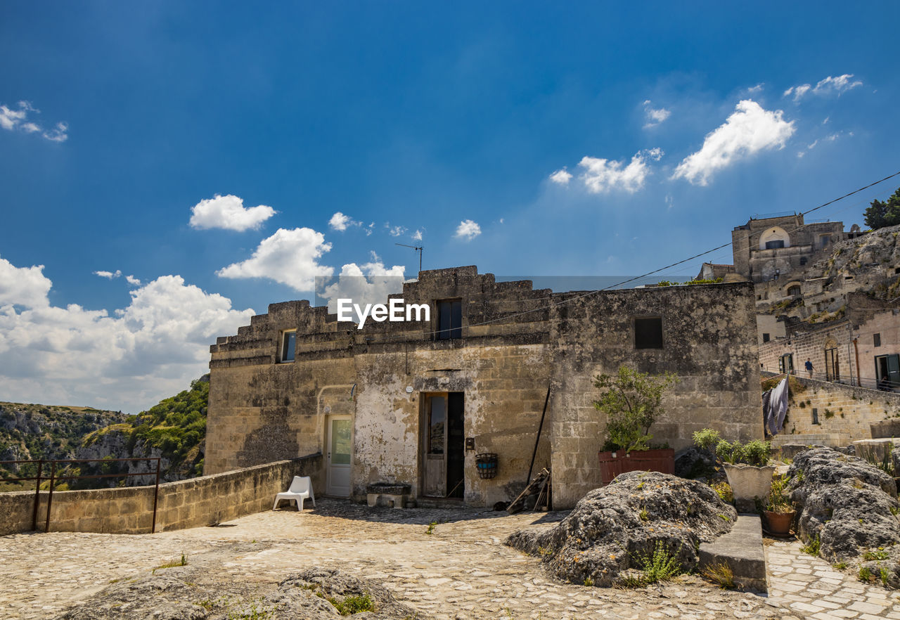 OLD BUILDINGS AGAINST SKY