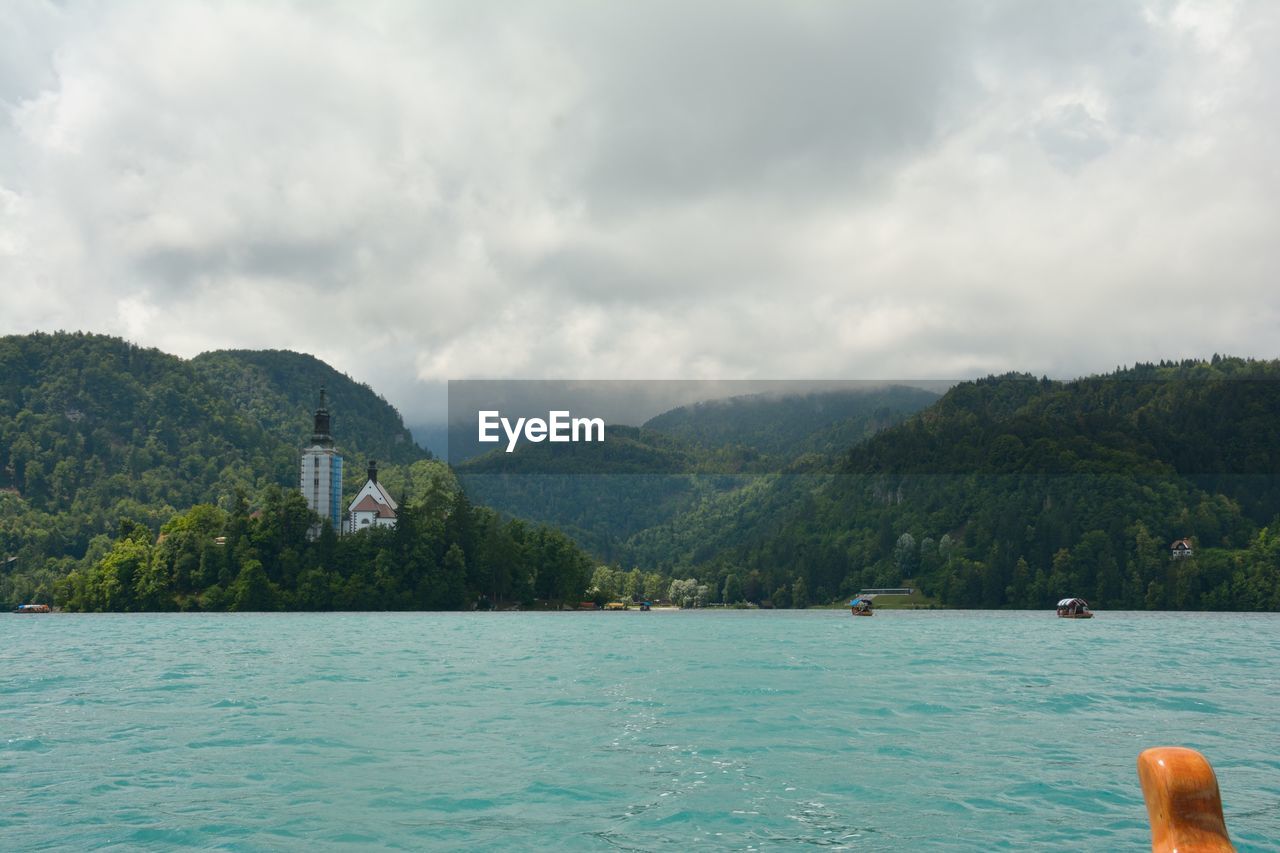 Scenic view of sea and mountains against sky