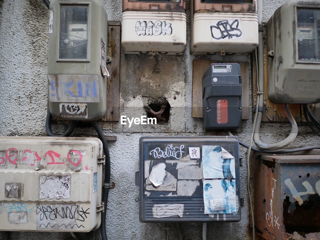 Electric switch boards on damaged wall