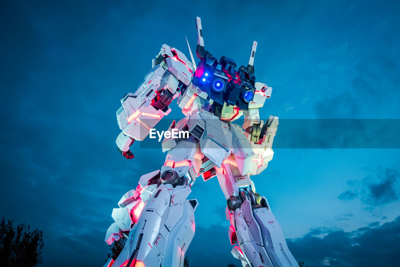 LOW ANGLE VIEW OF PEOPLE AT MUSIC CONCERT AGAINST SKY