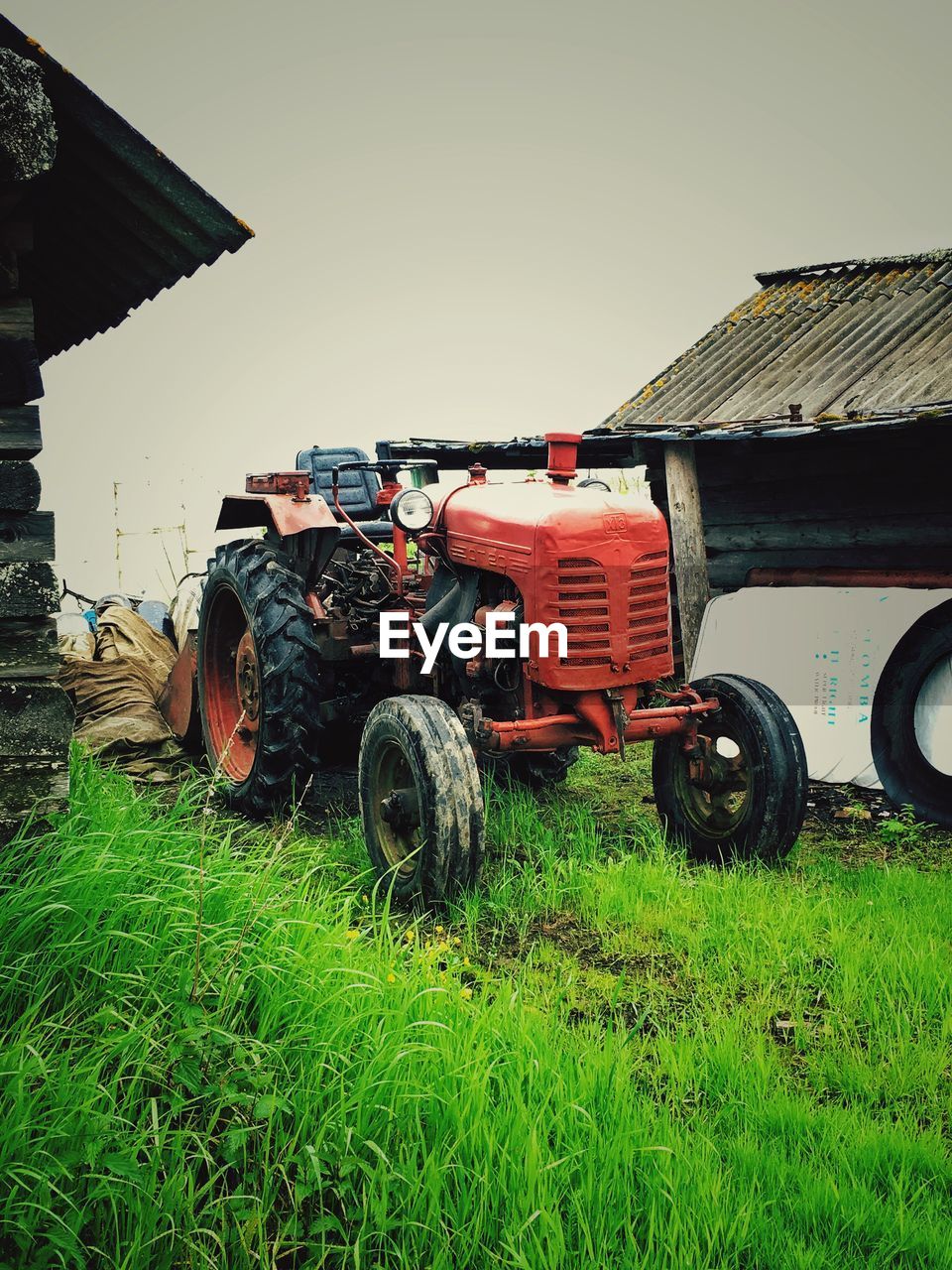 TRACTOR ON FIELD AGAINST SKY