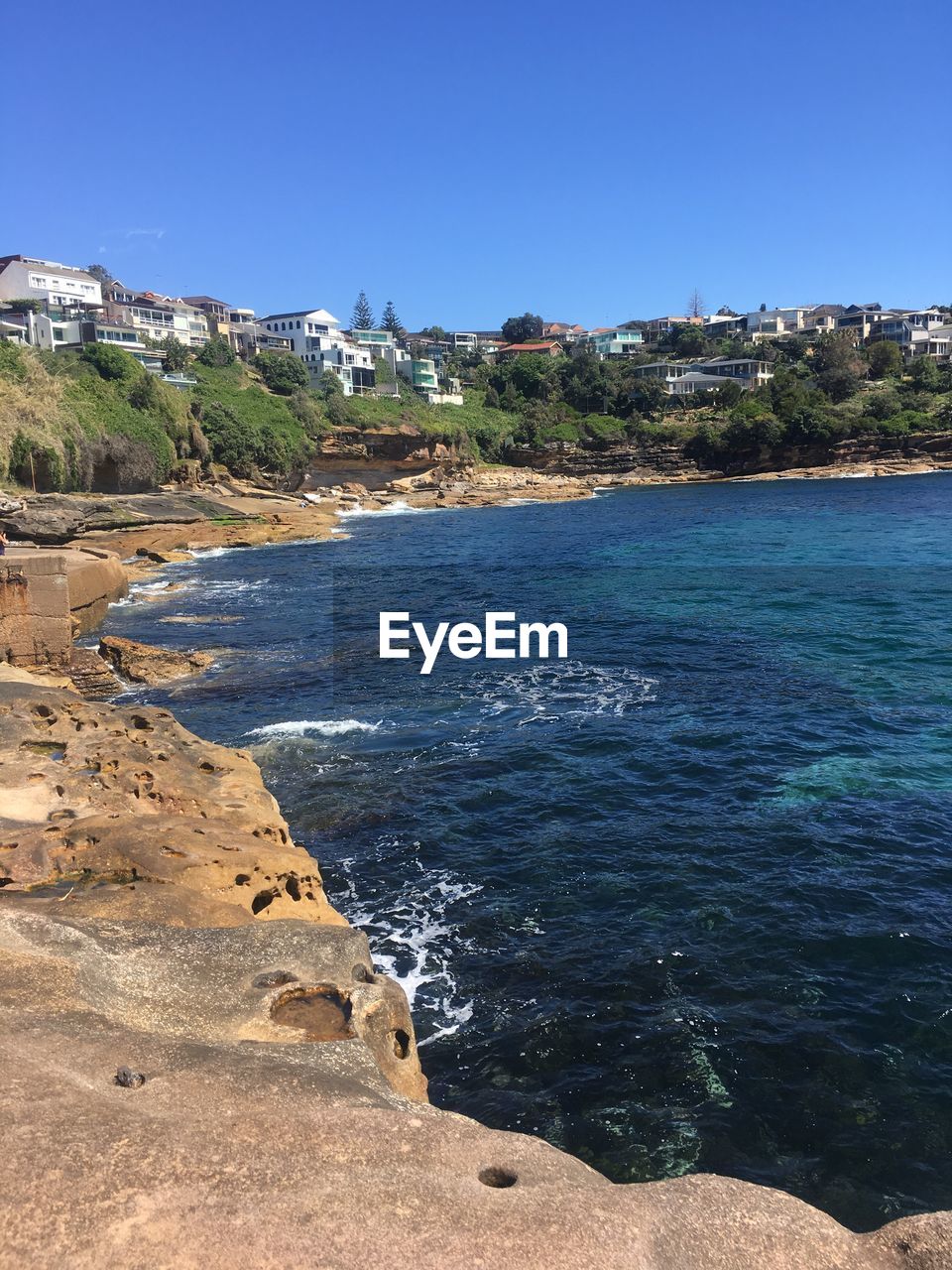 Scenic view of sea against clear blue sky