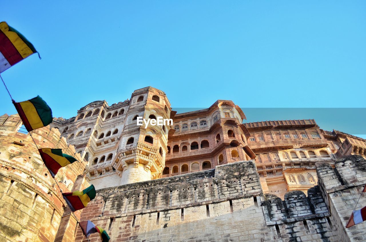Mehrangarh fort, low angle view of historical building against clear blue sky
