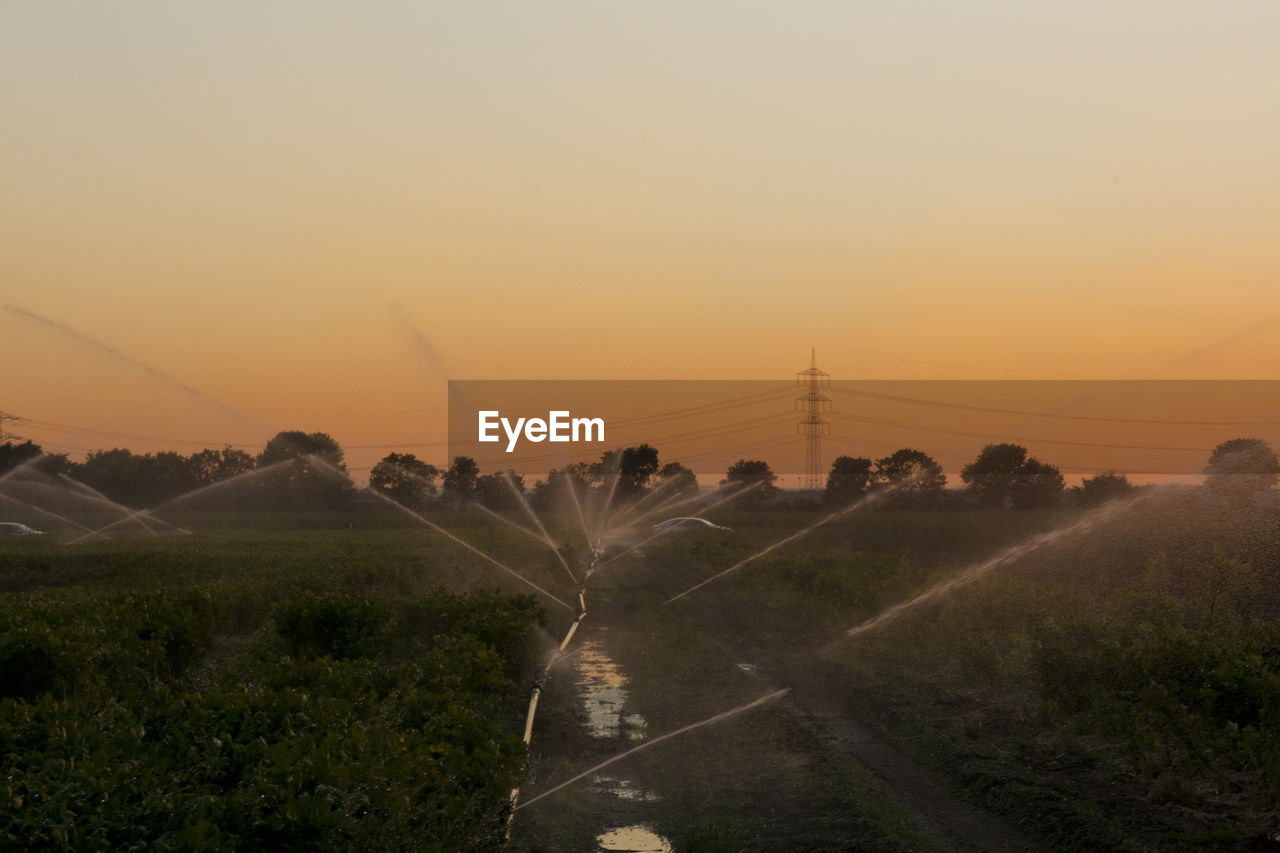 Scenic view of field against sky at dusk