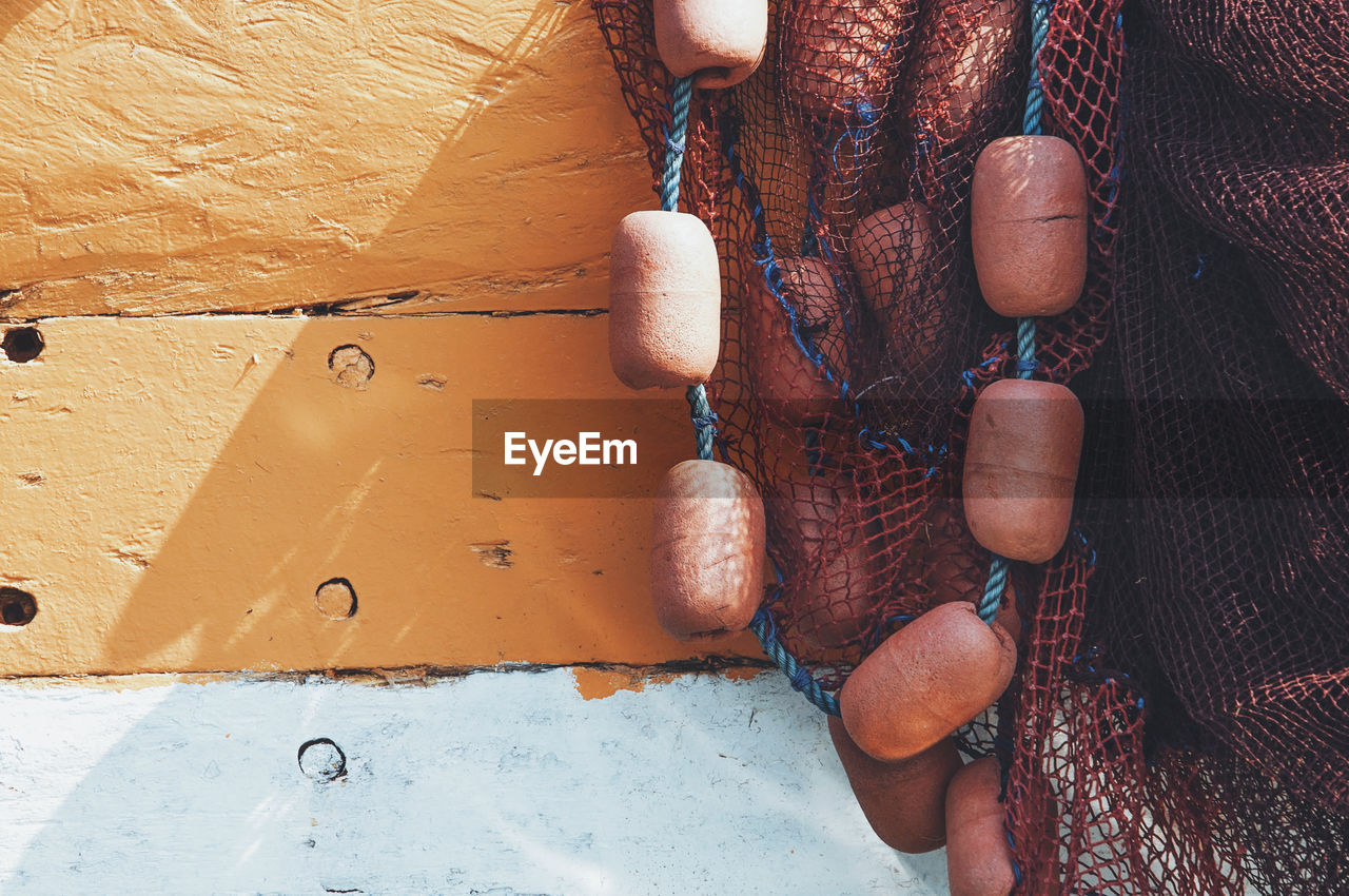 Close-up of fishing net against wall