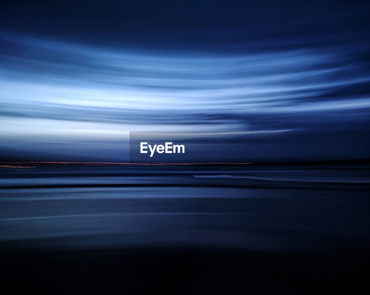 Full frame horizon over the sea with adamski effect in blue hour