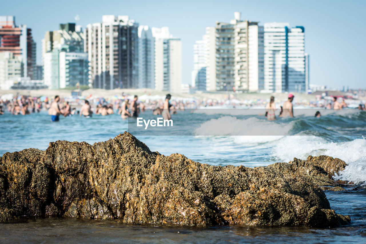 PANORAMIC VIEW OF BEACH AGAINST BUILDINGS