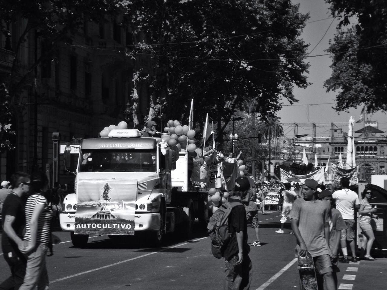 PEOPLE WALKING ON ROAD IN CITY