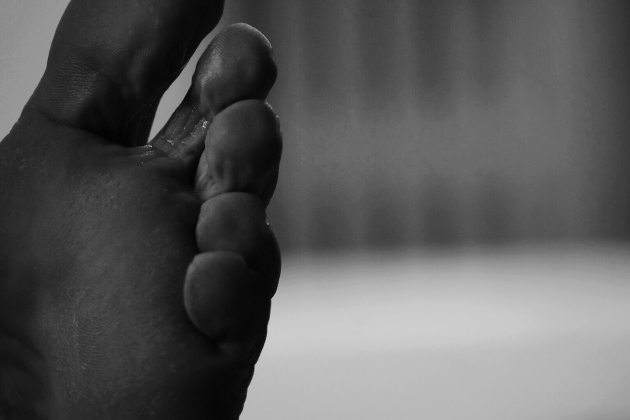 CLOSE-UP OF WOMAN HOLDING HANDS WITH TATTOO