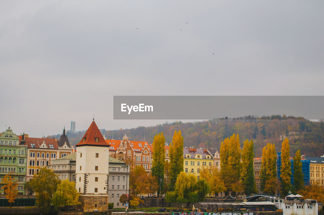 Colorful houses full of windows directed to the streets in an autumn afternoon in prague, czechia