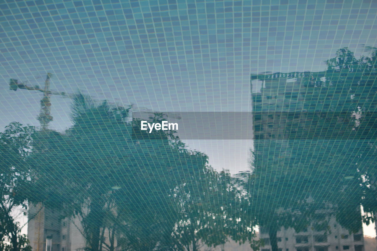 Reflection of buildings and trees on swimming pool