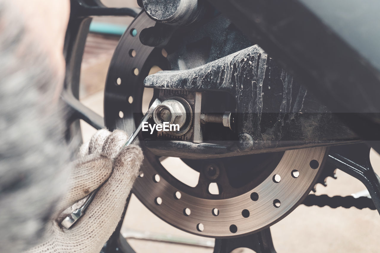 Cropped hand repairing wheel