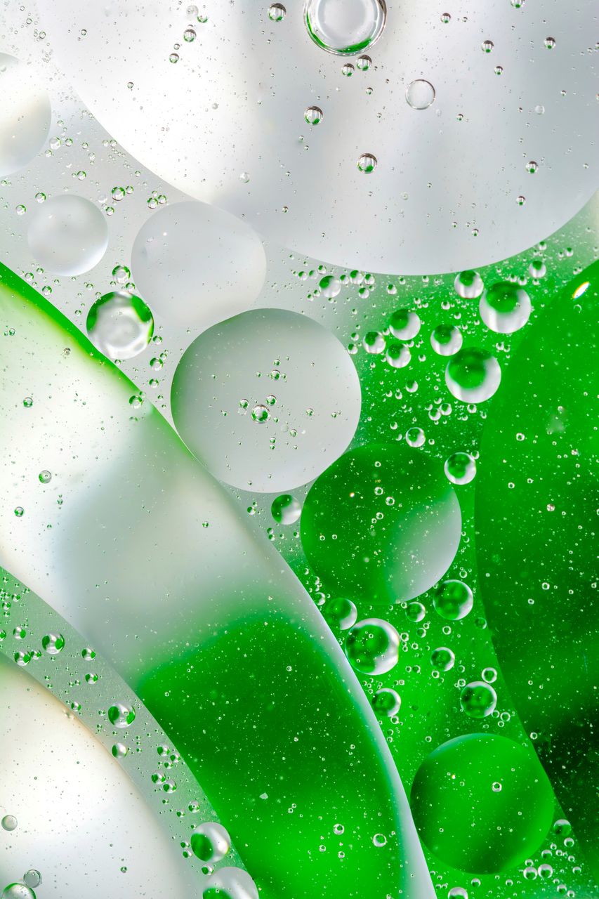 FULL FRAME SHOT OF WET GLASS WITH WATER DROPS