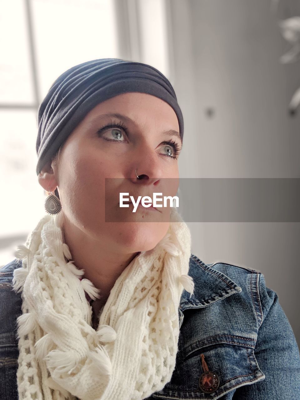 Low angle view of thoughtful woman looking away while sitting at home