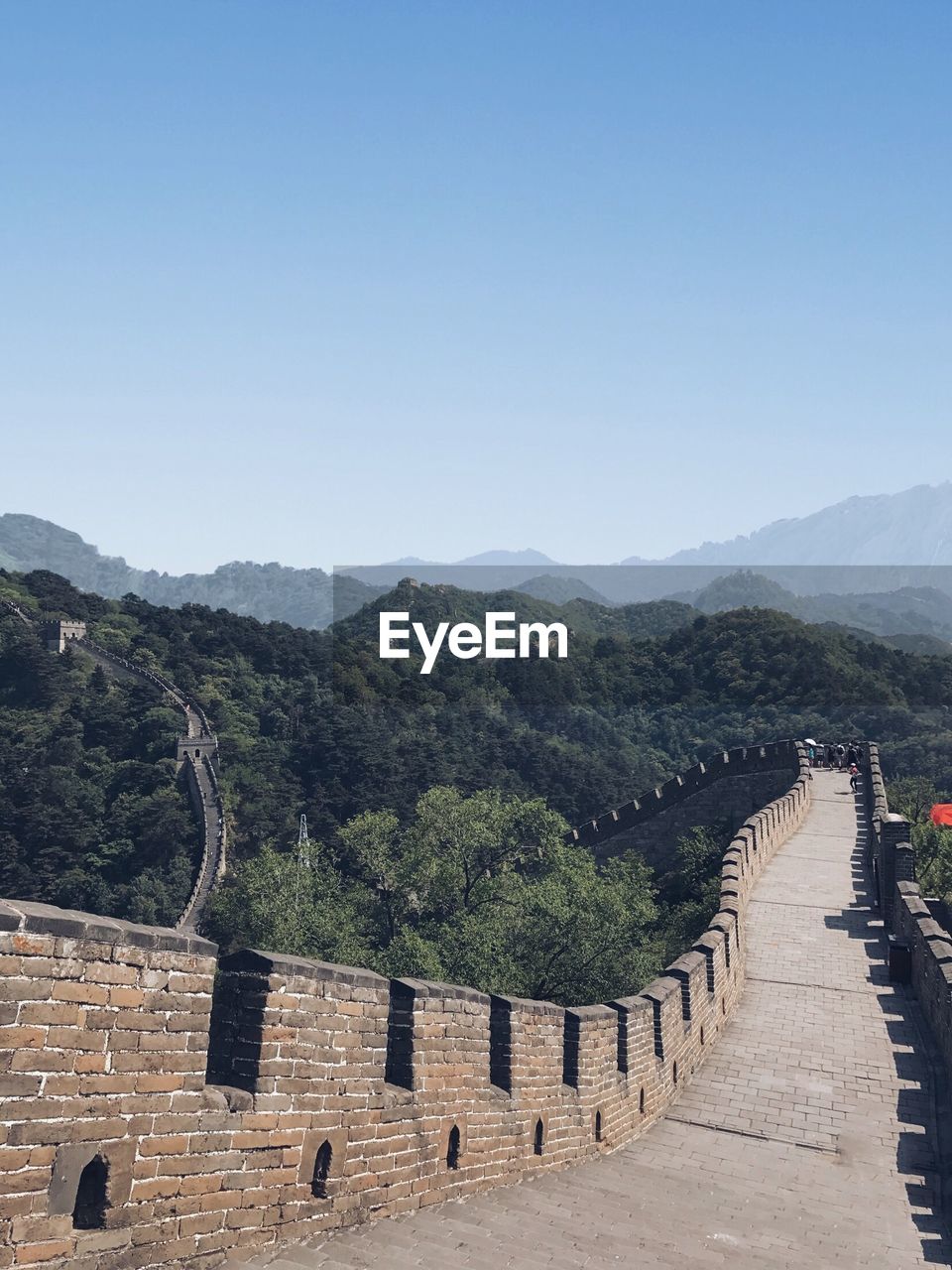 Great wall of china leading towards mountains against clear sky