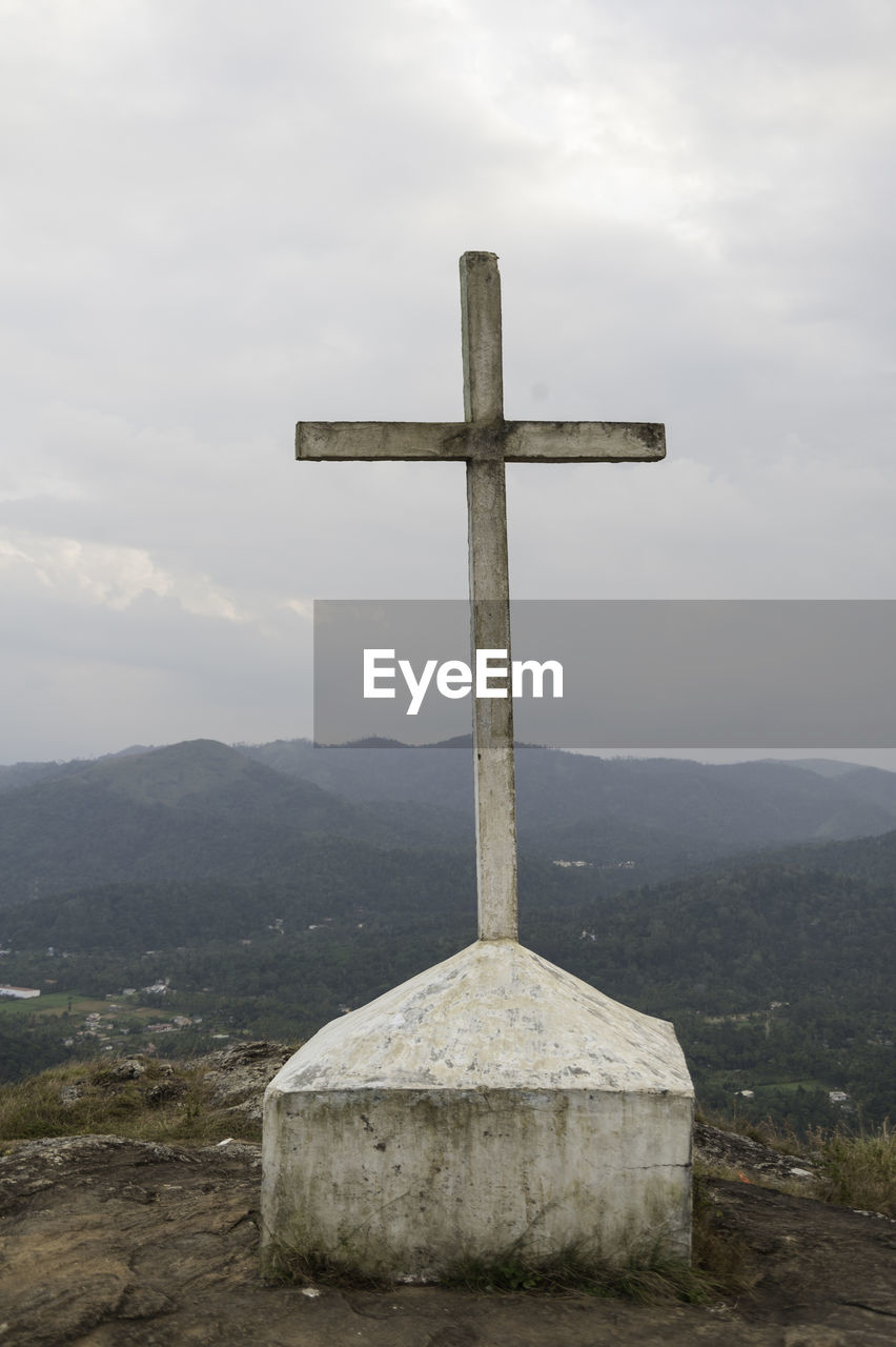 CROSS IN TEMPLE AGAINST MOUNTAIN