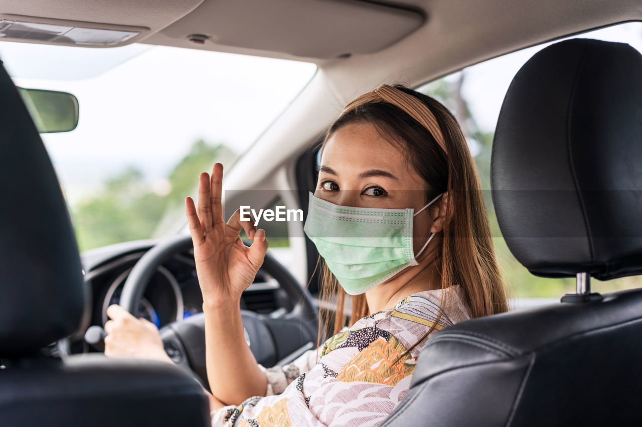 PORTRAIT OF WOMAN IN CAR