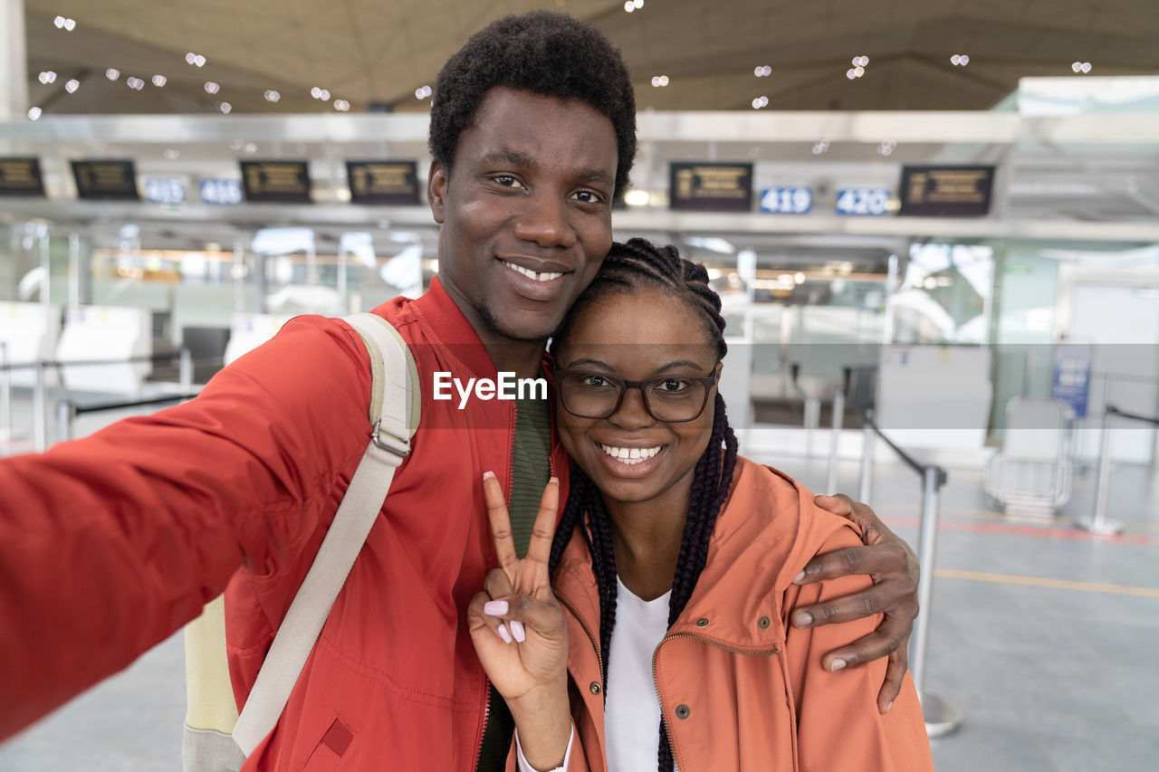 Portrait of a smiling young couple taking selfie