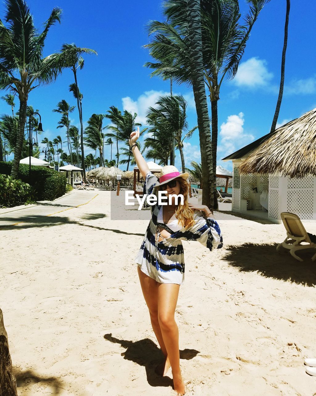 Portrait of woman standing at beach