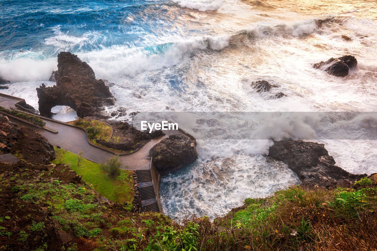 High angle view of rocks at sea shore