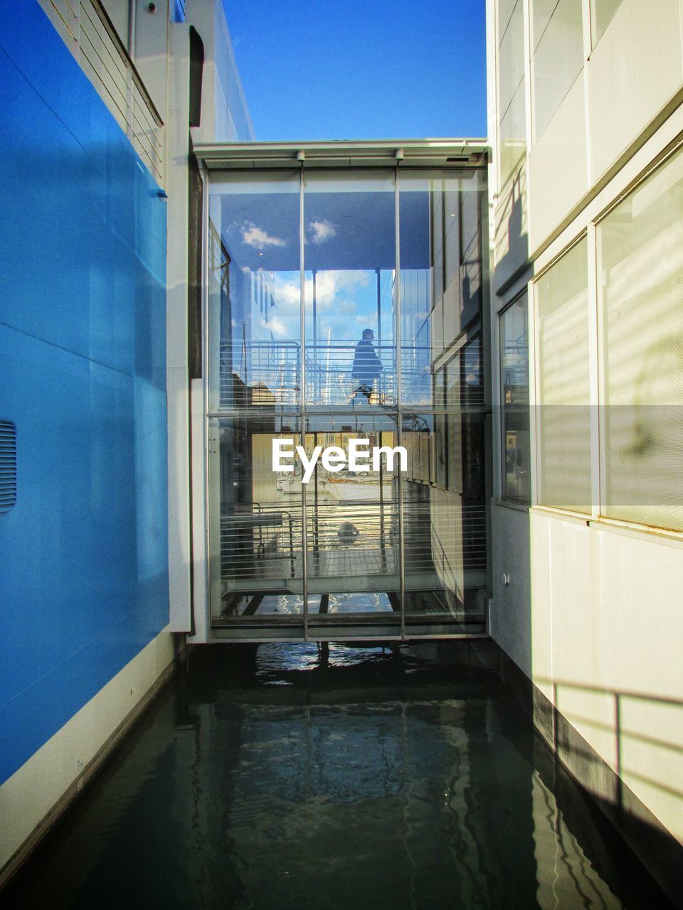 VIEW OF BUILDING AGAINST BLUE SKY