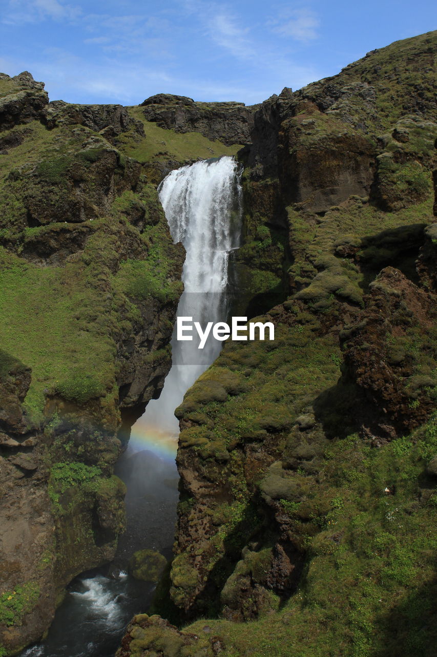 WATER FLOWING THROUGH ROCKS IN A WATERFALL