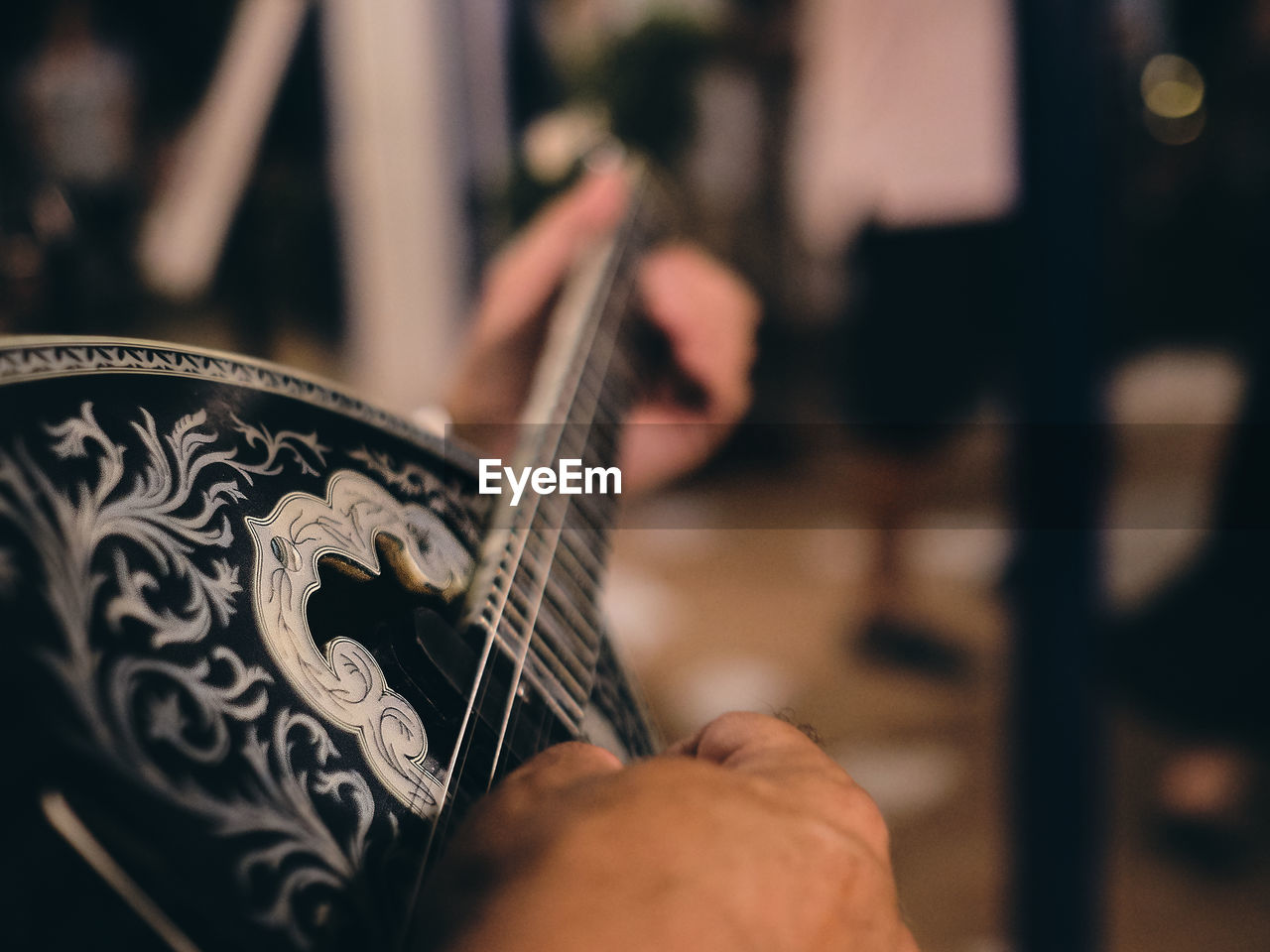 Cropped hands of person playing string instrument