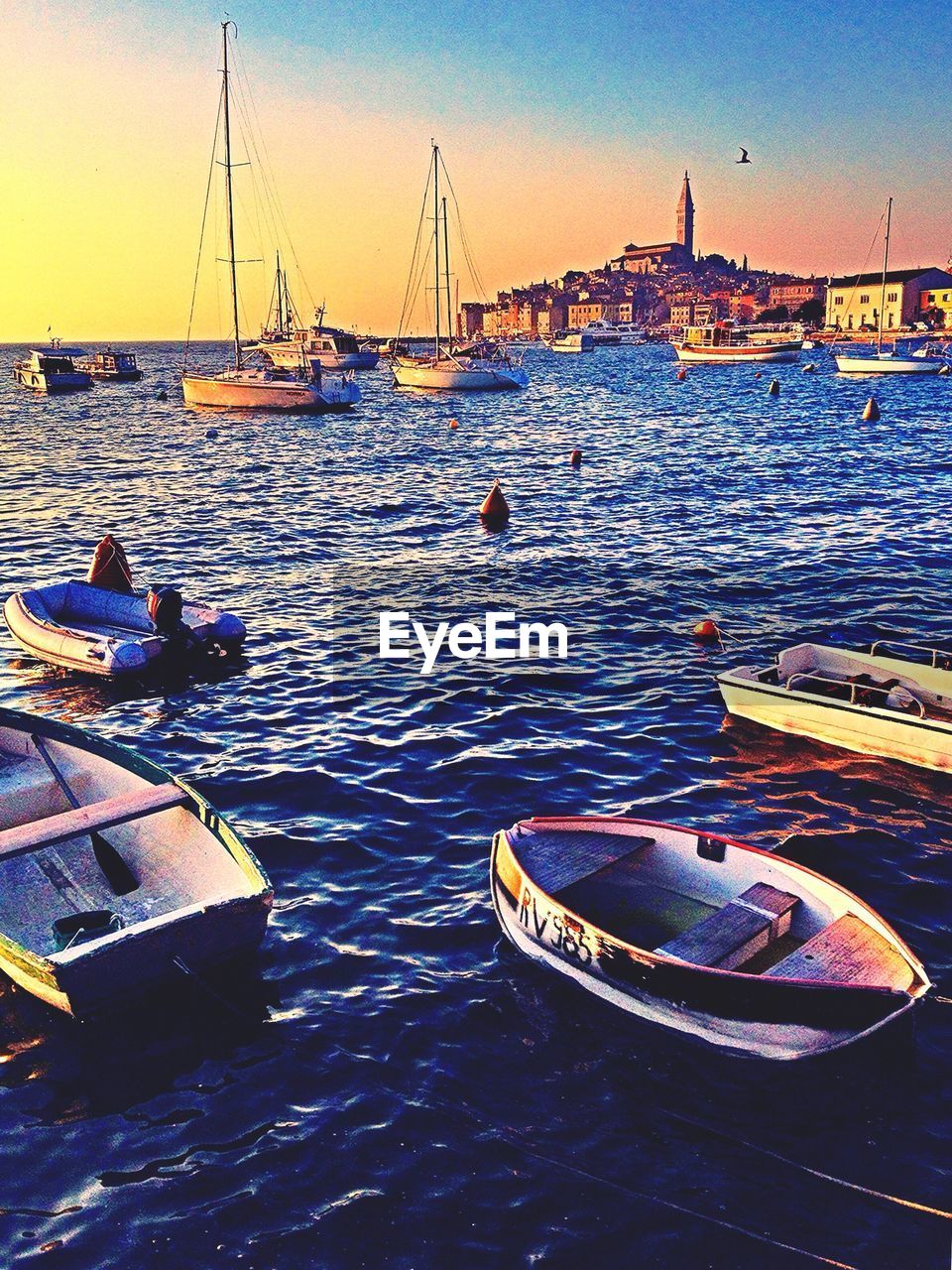 Boats moored on sea against sky