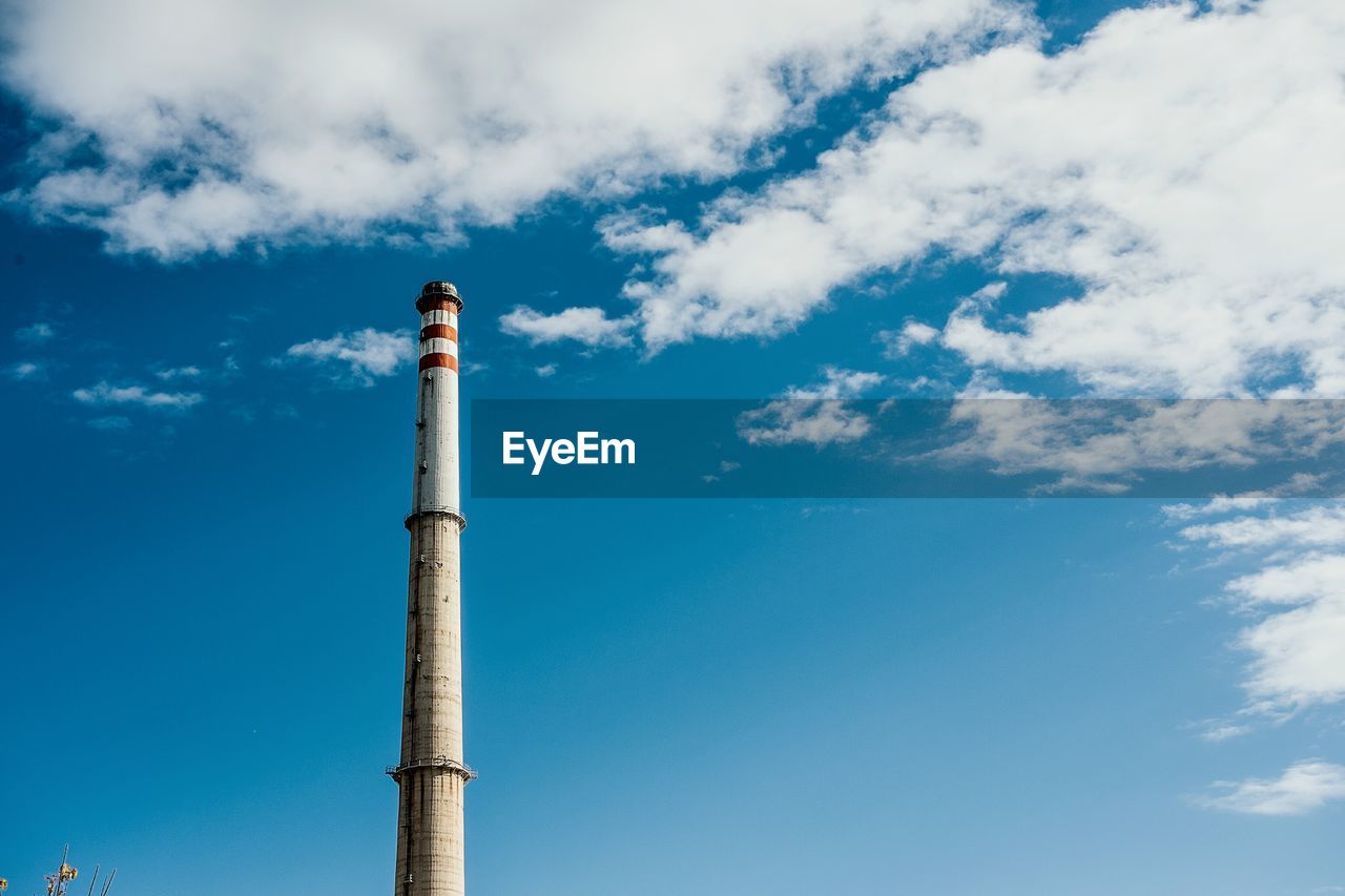 LOW ANGLE VIEW OF SMOKE STACKS AGAINST SKY