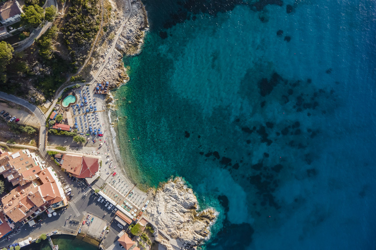 water, aerial view, aerial photography, sea, high angle view, land, nature, architecture, beach, coast, city, travel destinations, travel, blue, built structure, coastline, building exterior, outdoors, transportation, no people, scenics - nature, day, environment, landscape, tourism, beauty in nature, turquoise colored, nautical vessel, island, bay, bird's-eye view, tree, holiday, panoramic, terrain, vacation, building, trip