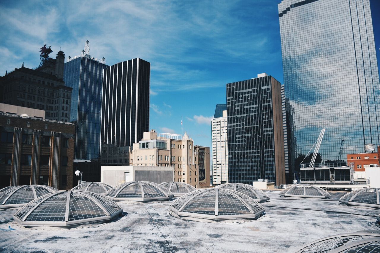Urban skyline against sky