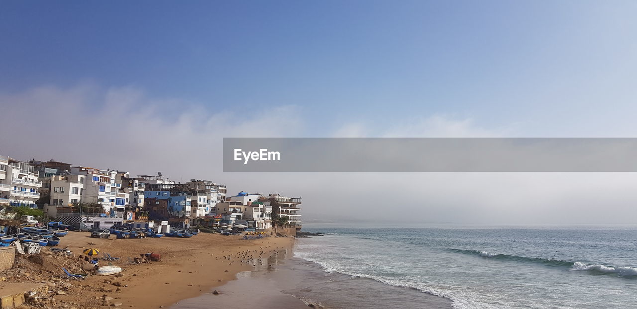 SCENIC VIEW OF SEA AGAINST BUILDINGS