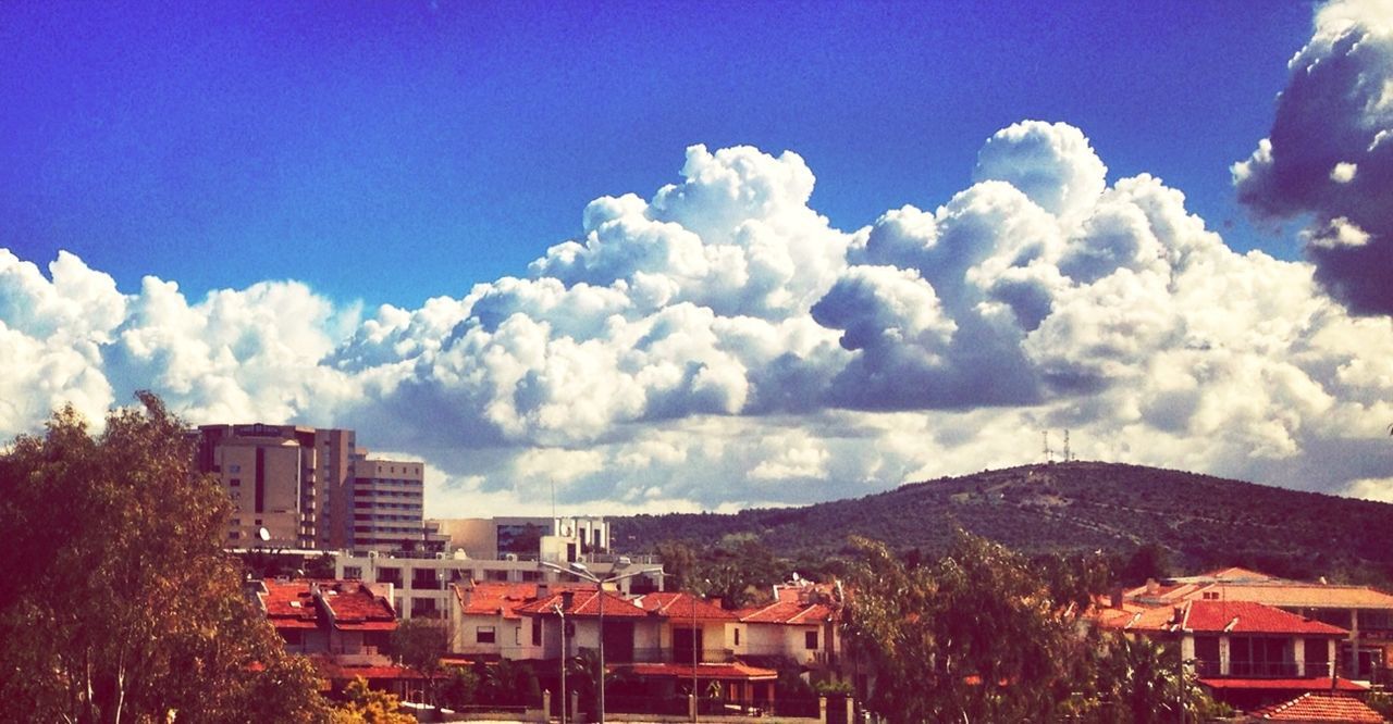 TOWN AGAINST CLOUDY SKY