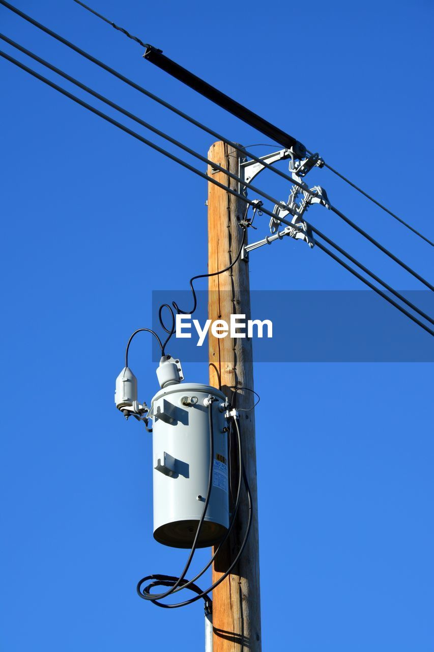 Low angle view of power line against clear blue sky