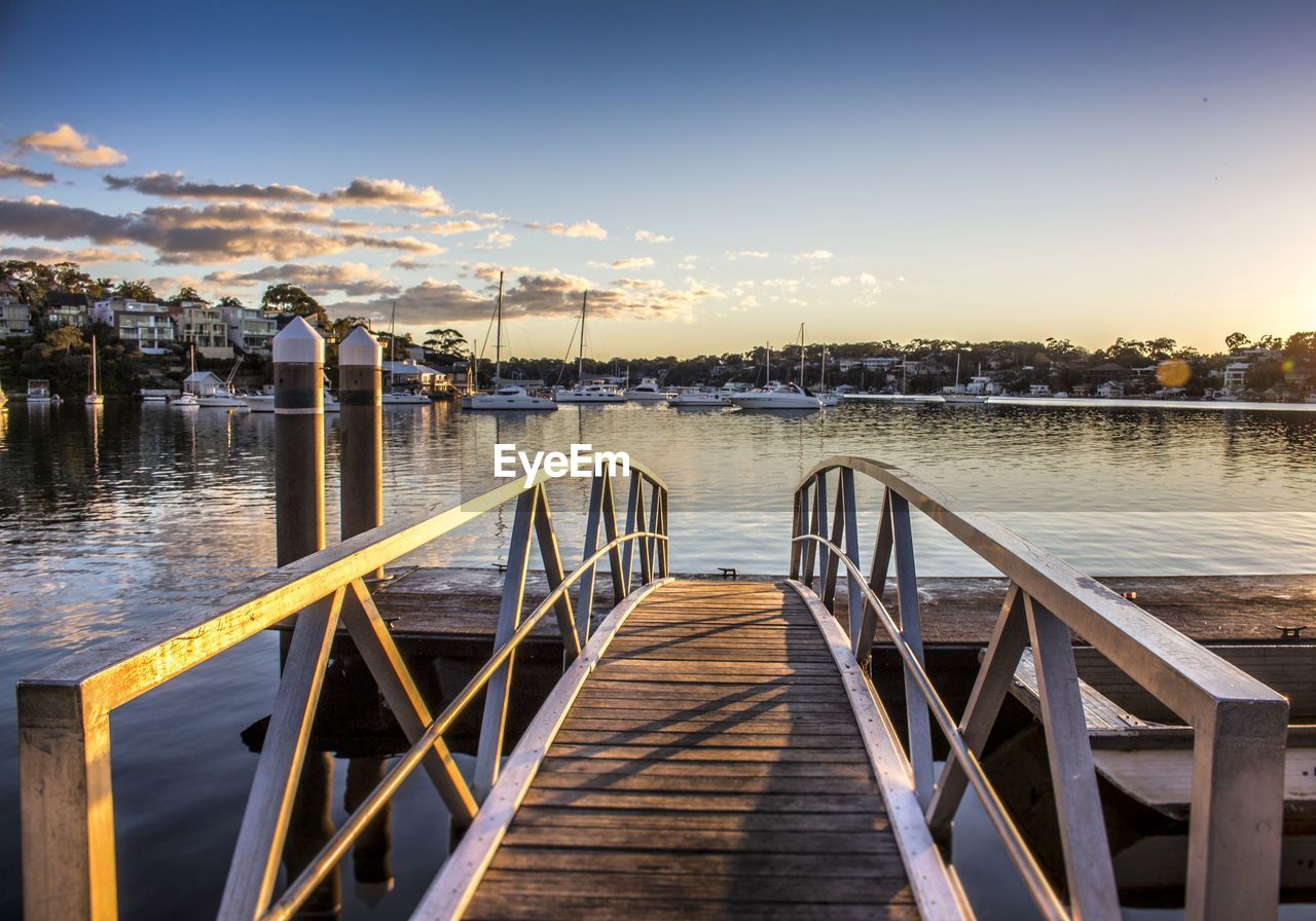 Pier on lake with boats in background