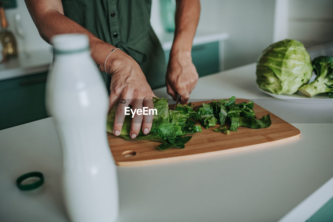 Midsection of man preparing food in kitchen