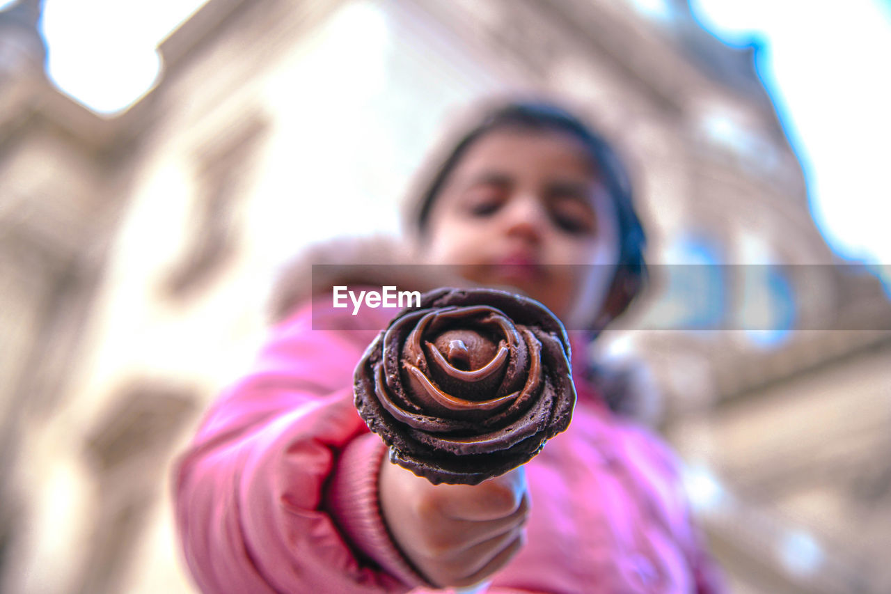 Close-up of girl holding chocolate