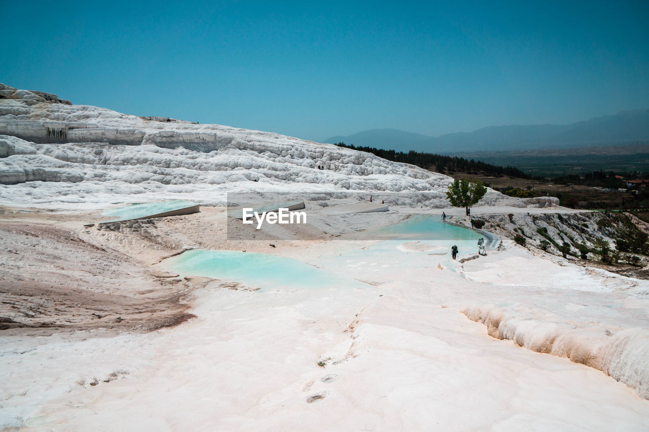 Scenic view of landscape against blue sky