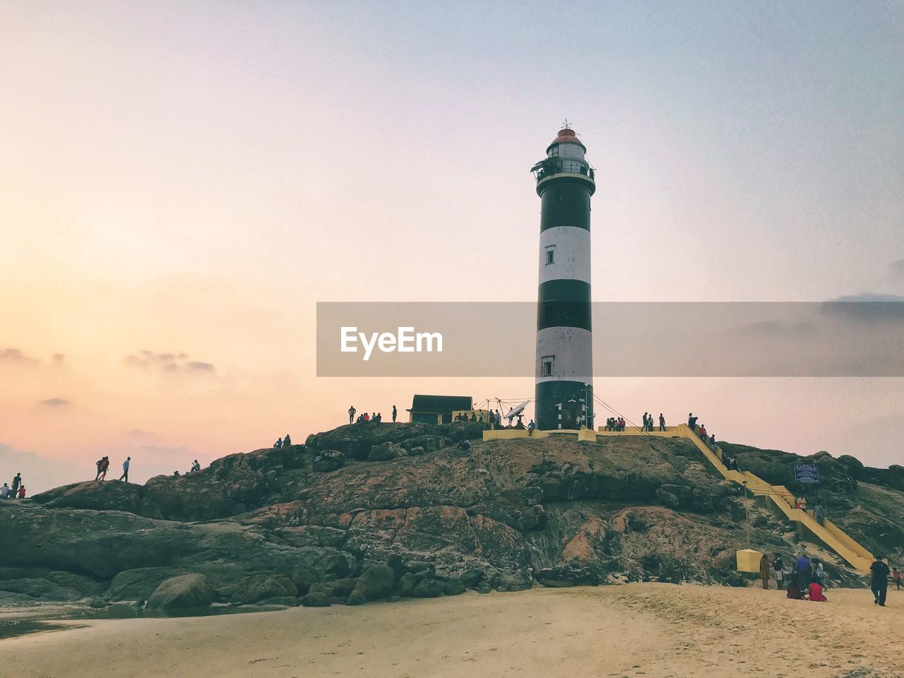 LIGHTHOUSE BY MOUNTAIN AGAINST SKY