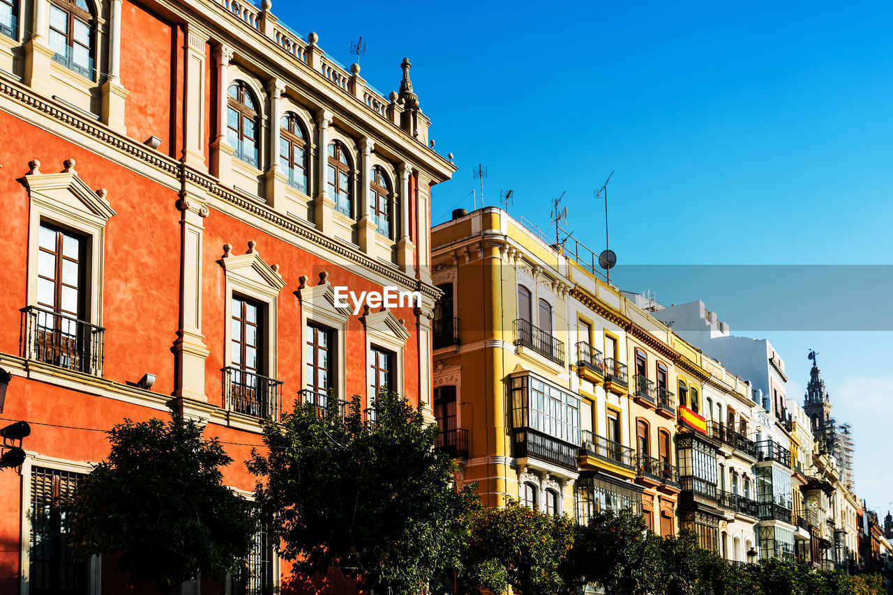 Low angle view of buildings against blue sky