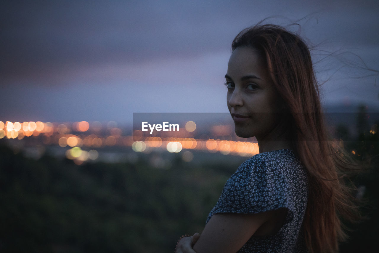 Portrait of woman standing against sky during sunset