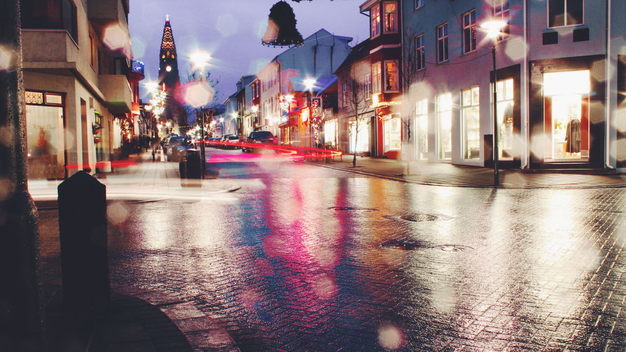 Illuminated city street at night